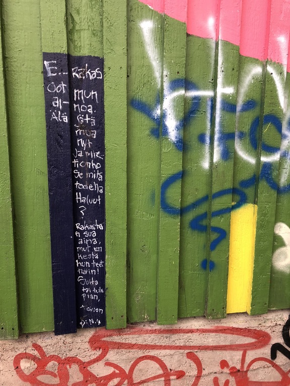 Kuva leikkipuiston aidasta, johon kirjoitettu rakkausviesti